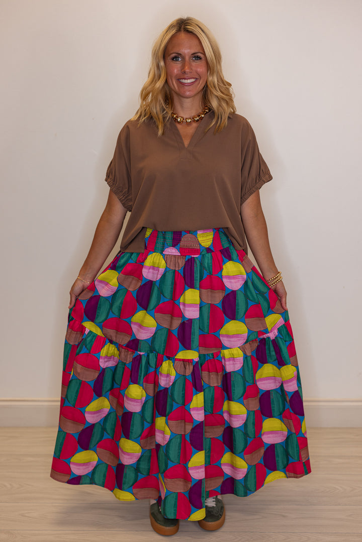 Women's smocked hot pink and multicolor print tiered poplin maxi skirt by Karlie showing relaxed, flowy fit