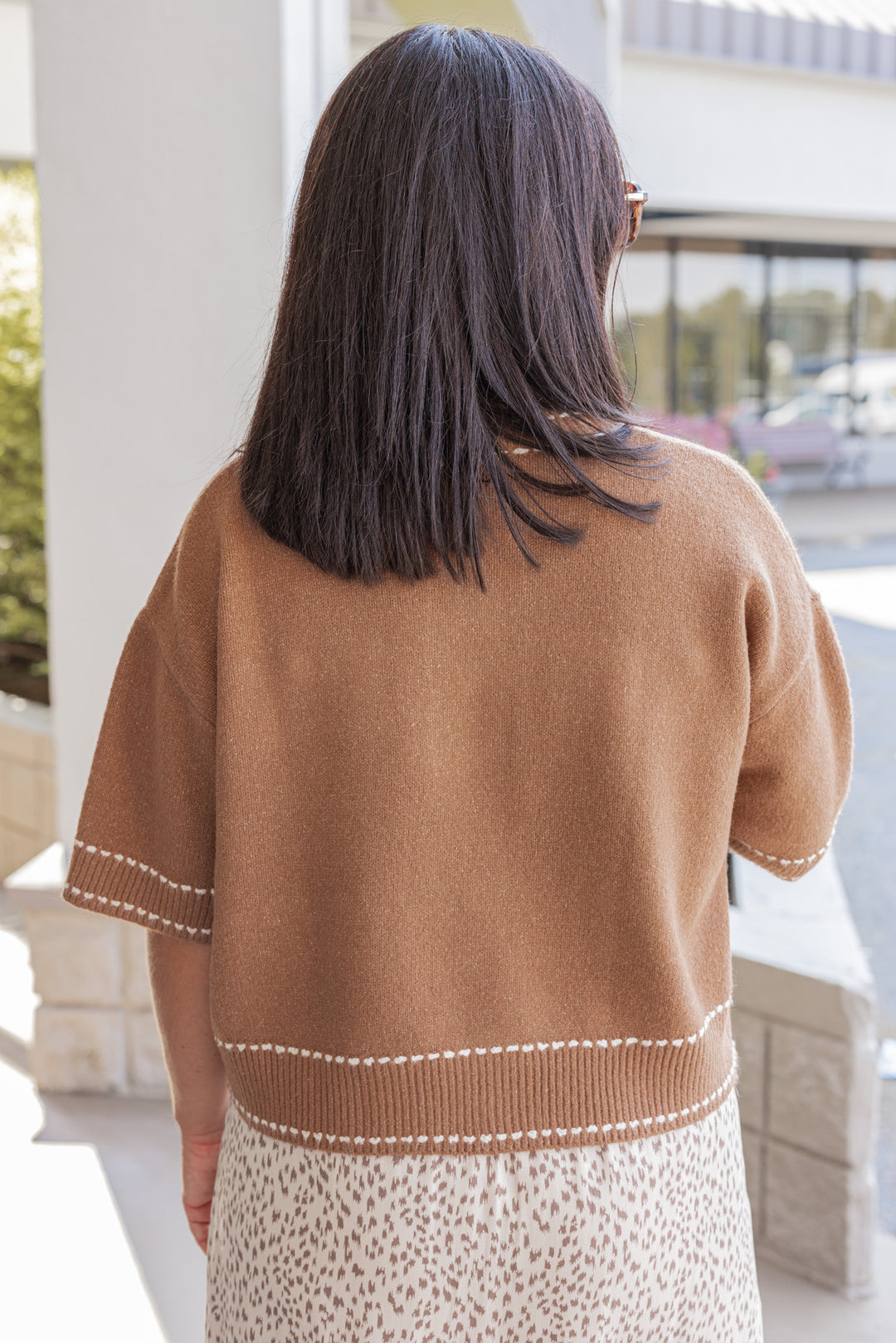 Women's caramel button front sweater cardigan with cream stitching detail by Entro showing up close back view