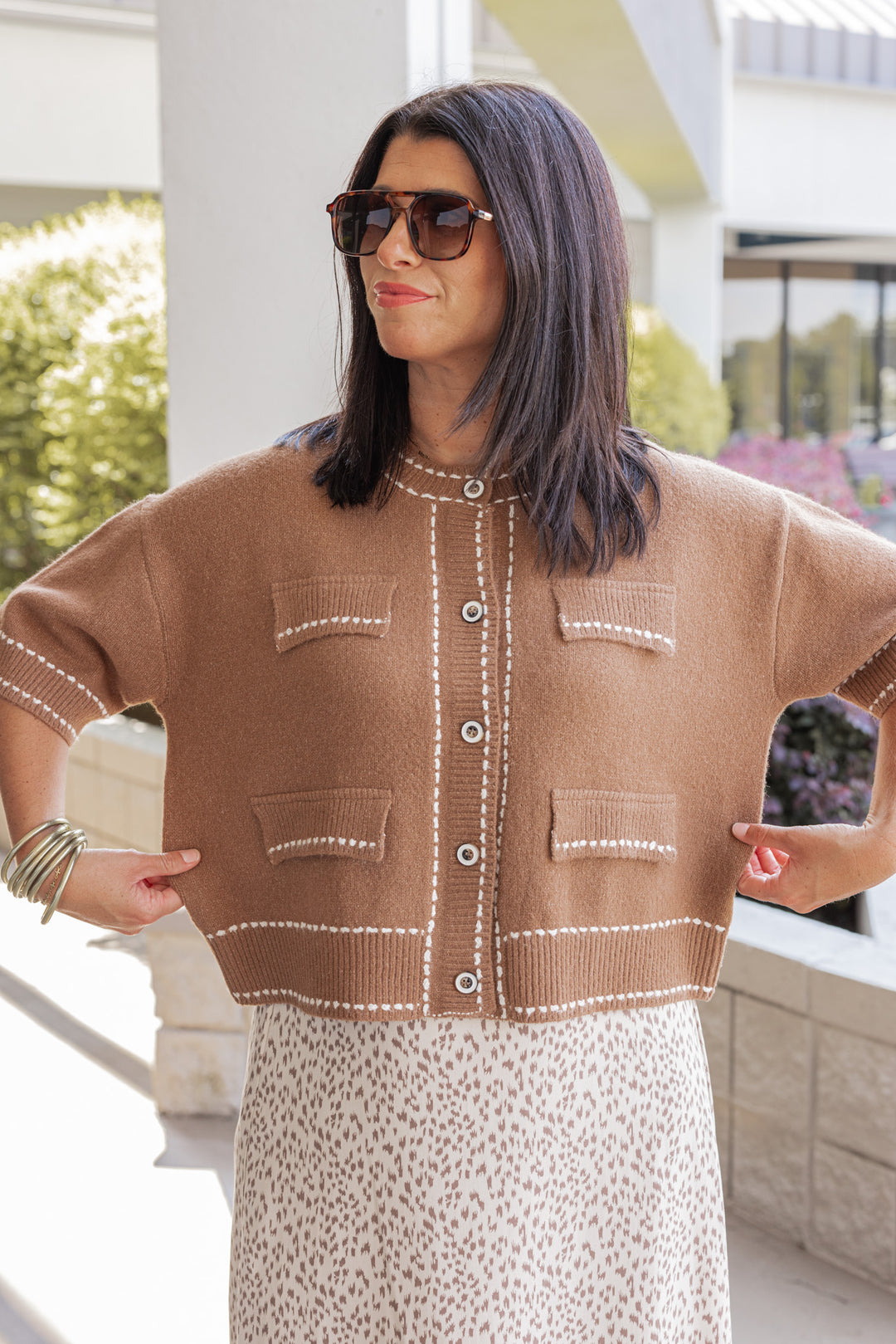 Women's caramel button front sweater cardigan with cream stitching detail by Entro showing relaxed fit