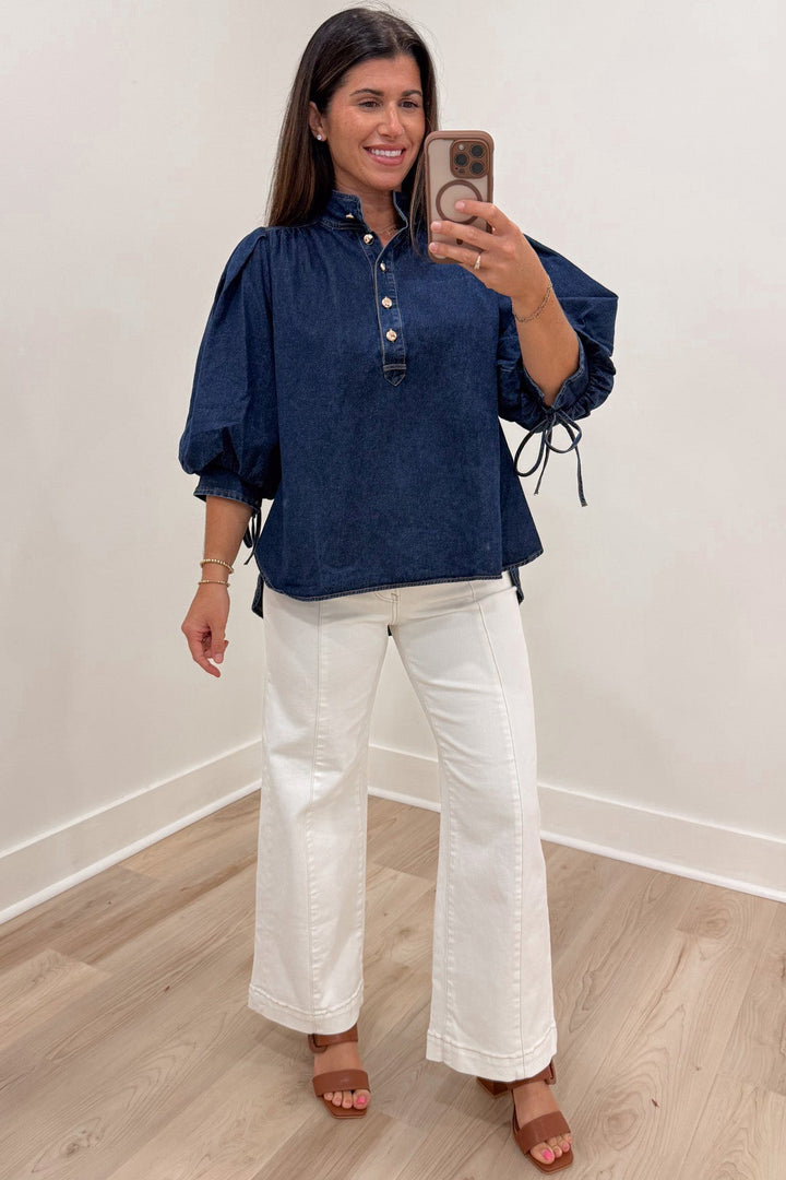 solid dark blue denim 3/4 length puff sleeve mock neckline button front bodice top with rounded bottom hem