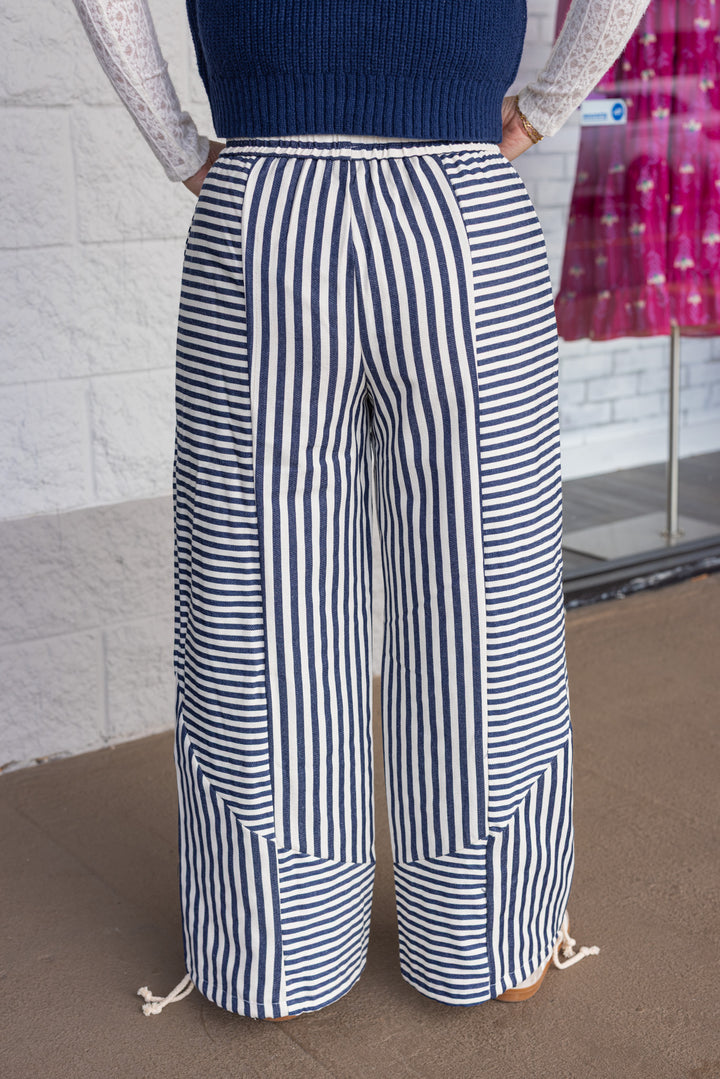 Women's dark blue and cream striped wide leg jogger pants with cinch ankle by &merci showing up close back view