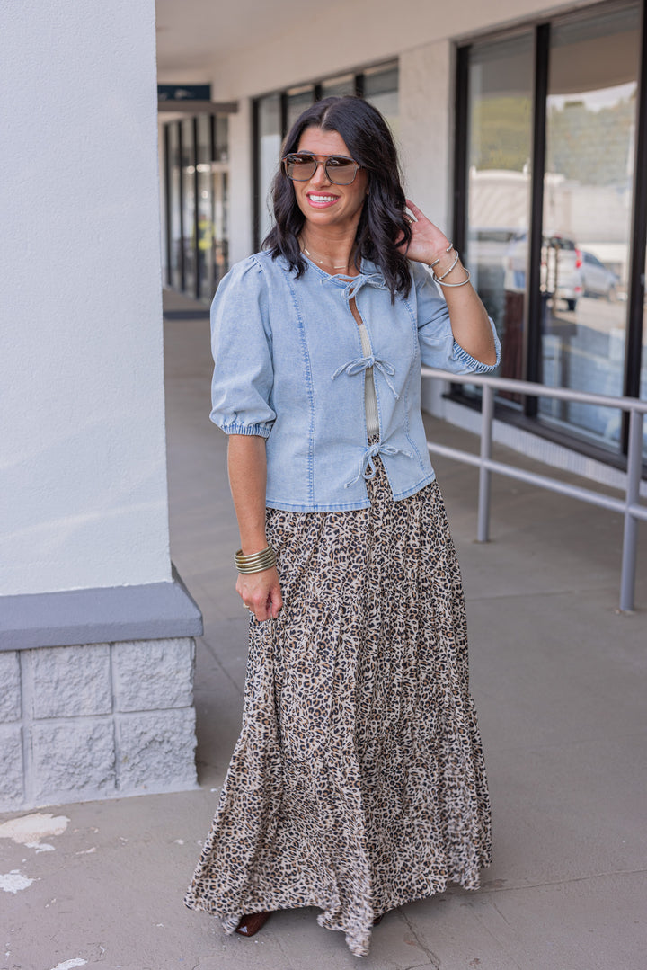 Blue denim top with bow tie closures down the open front peek a boo bodice by Wishlist showing full front view