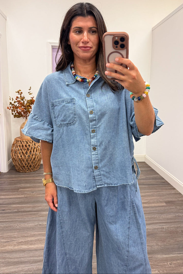 washed blue denim button front short sleeve top with cinch drawstring sides