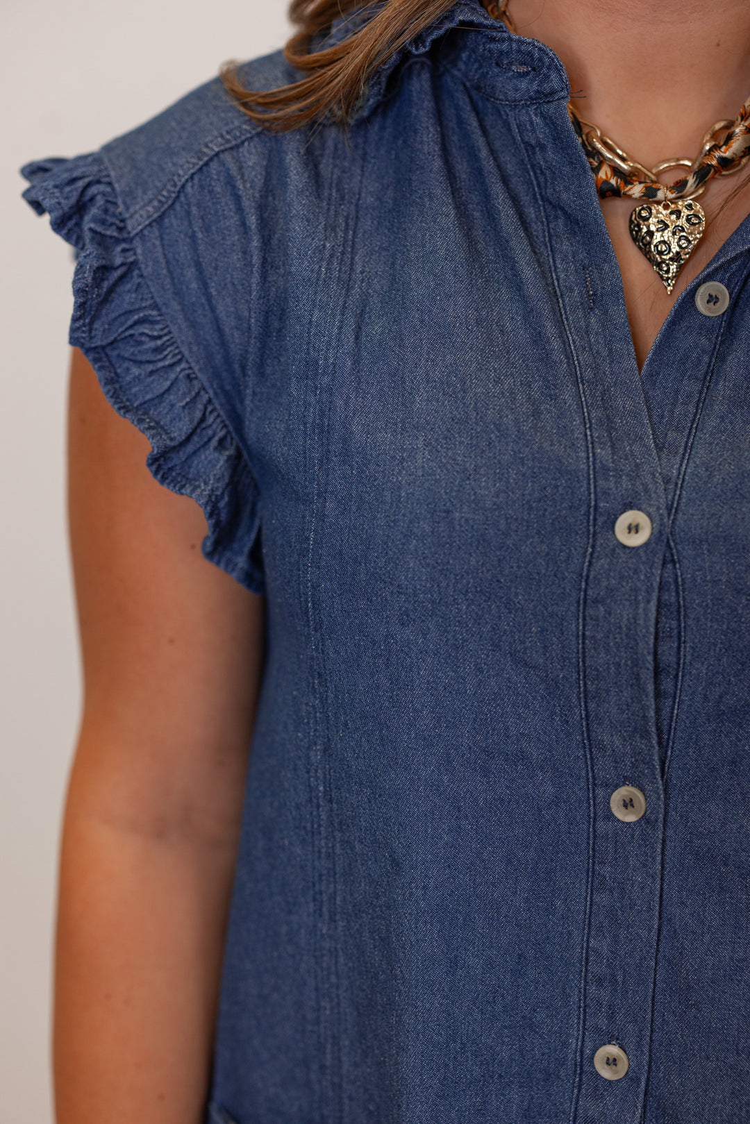Dark blue denim button down dress with ruffle details by Entro showing button front and ruffle details