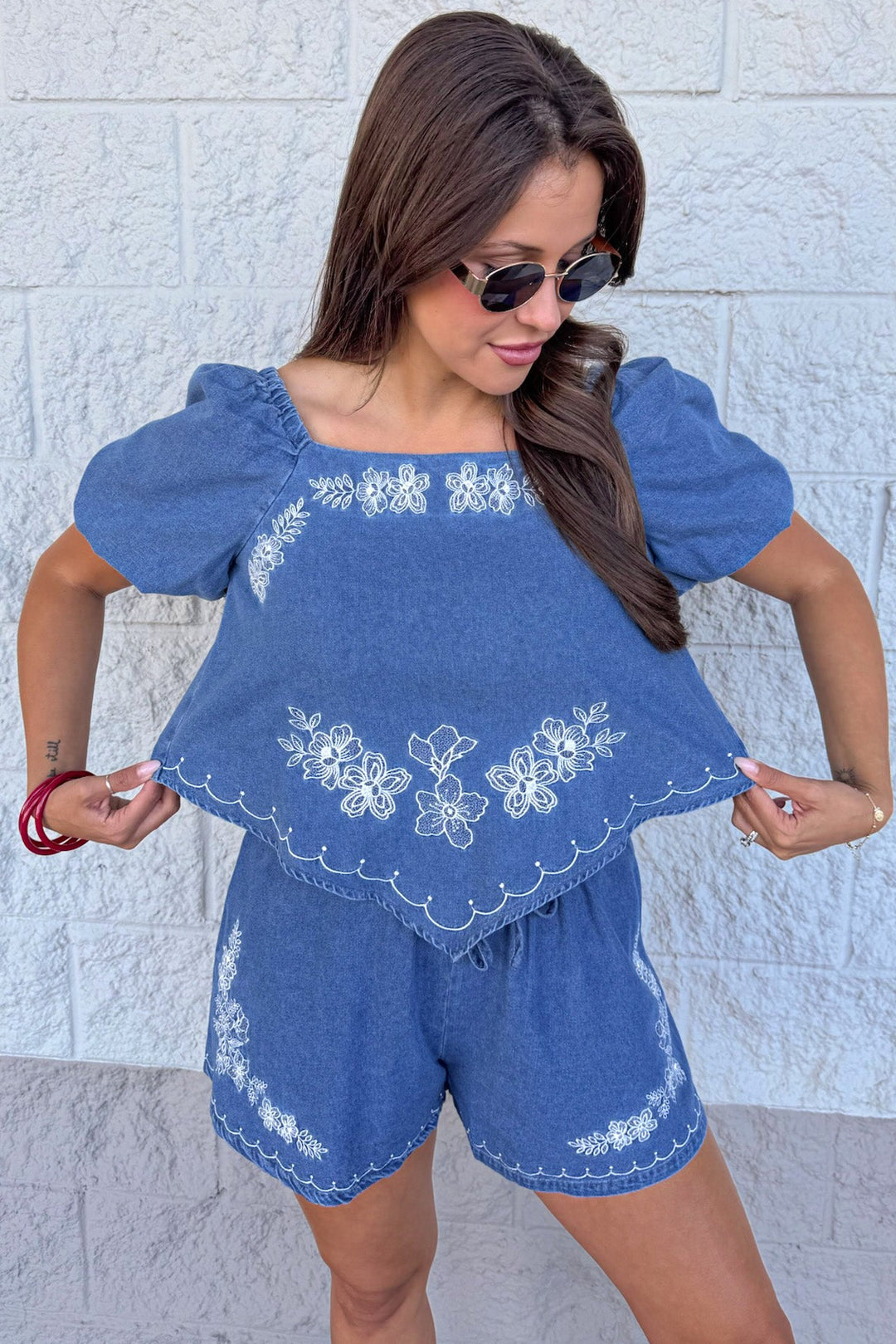 medium washed blue denim white floral embroidery relaxed silhouette top