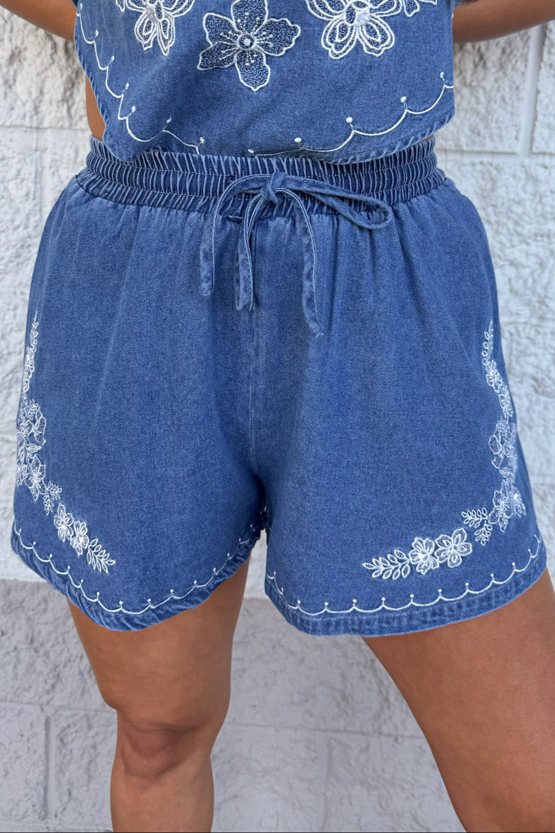 medium washed blue denim with white embroidery wide leg shorts