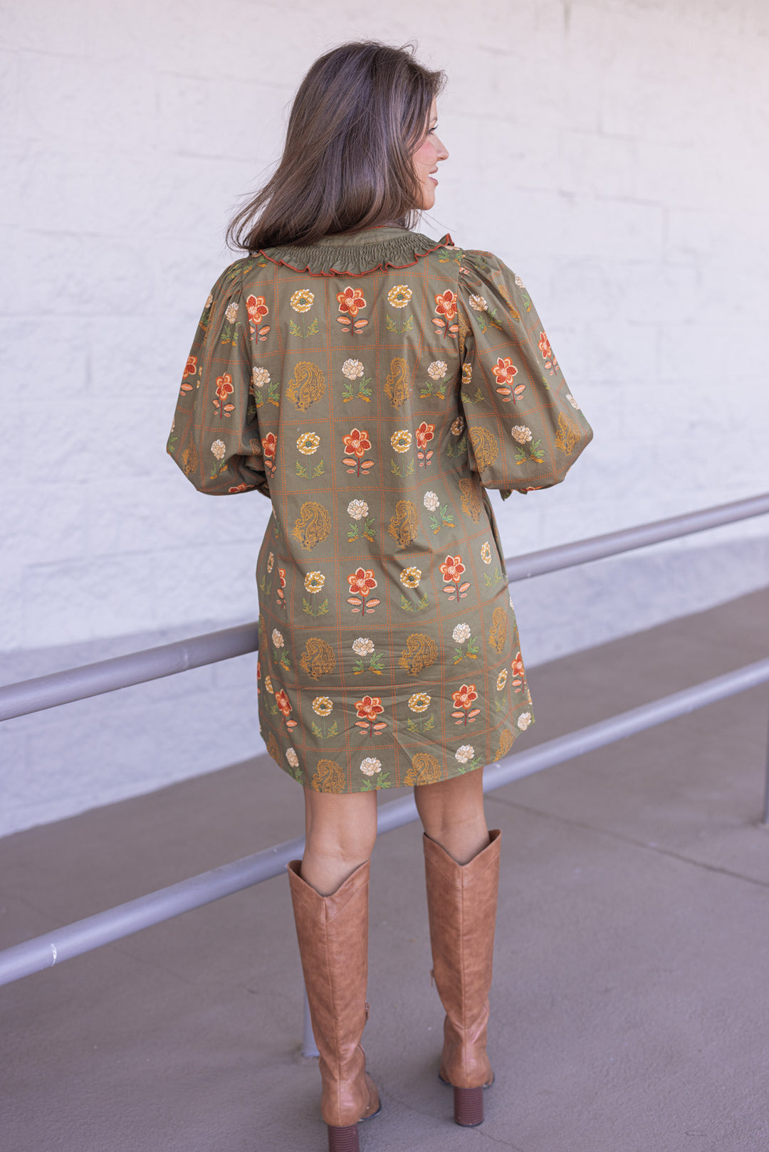 Women's olive dress with floral border print in orange and peach by Entro showing full back view