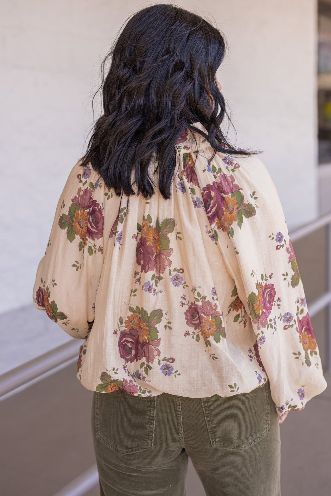 Women's ecru bubble hem top with large burgundy and olive floral print by Entro showing back view