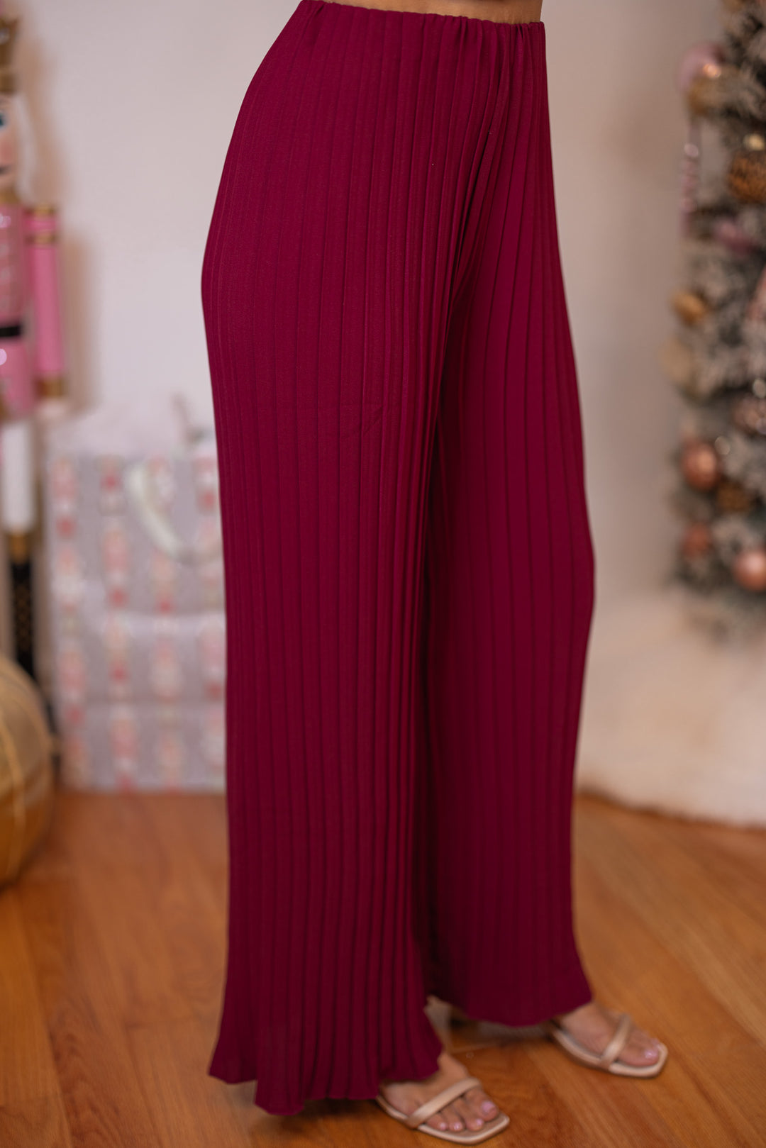 Women's holiday wear burgundy pants set by Wishlist showing pant's slight side view