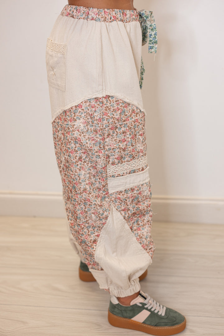 Women's oatmeal twill wide leg jogger pants with multicolor floral patches by POL showing up close side view
