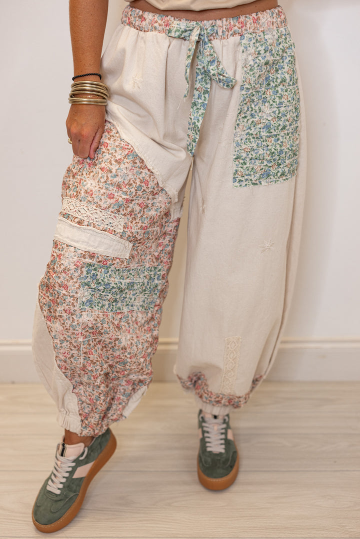 Women's oatmeal twill wide leg jogger pants with multicolor floral patches by POL showing up close front view