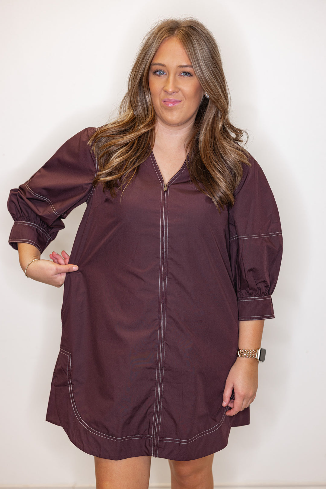 Women's chocolate brown mini dress with cream contrasting stitching throughout by Entro showing true to size fit