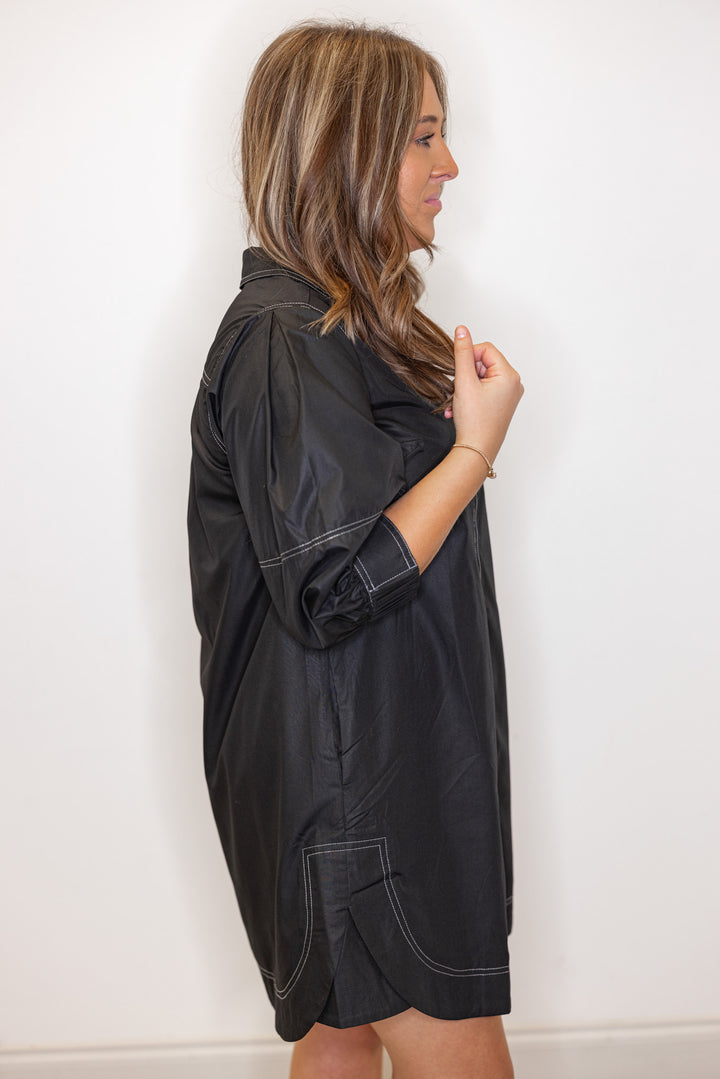 Women's black mini dress with cream contrasting stitching throughout by Entro showing up close side view