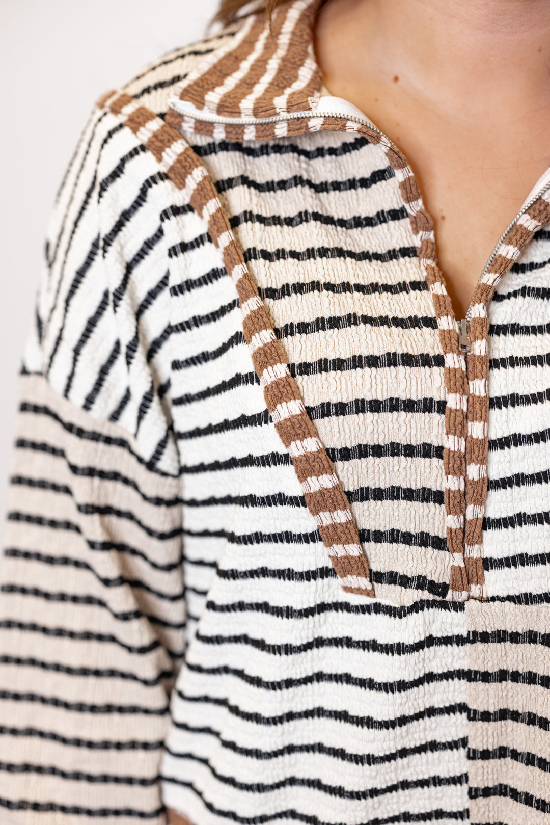 Women's taupe, cream and mocha colorblock half zip top with black stripes by Blu Pepper showing up close view of textured knit fabric