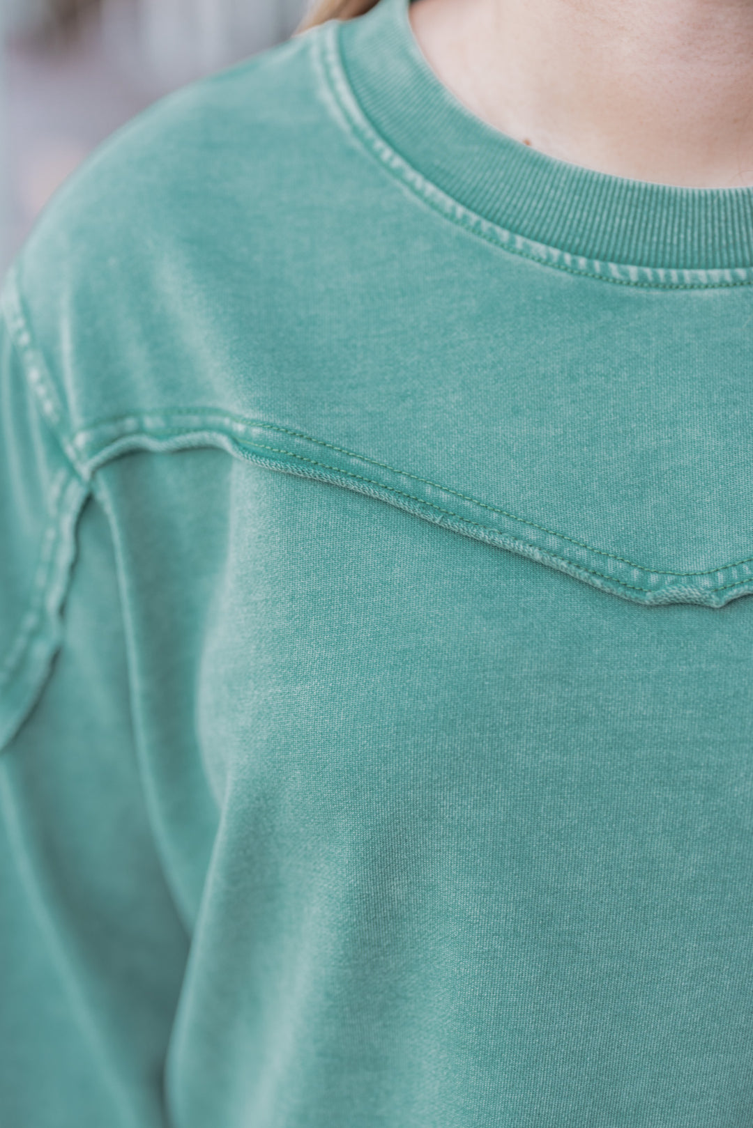 Women's mineral washed pine green terry knit pullover by Easel showing raw/reverse seam details