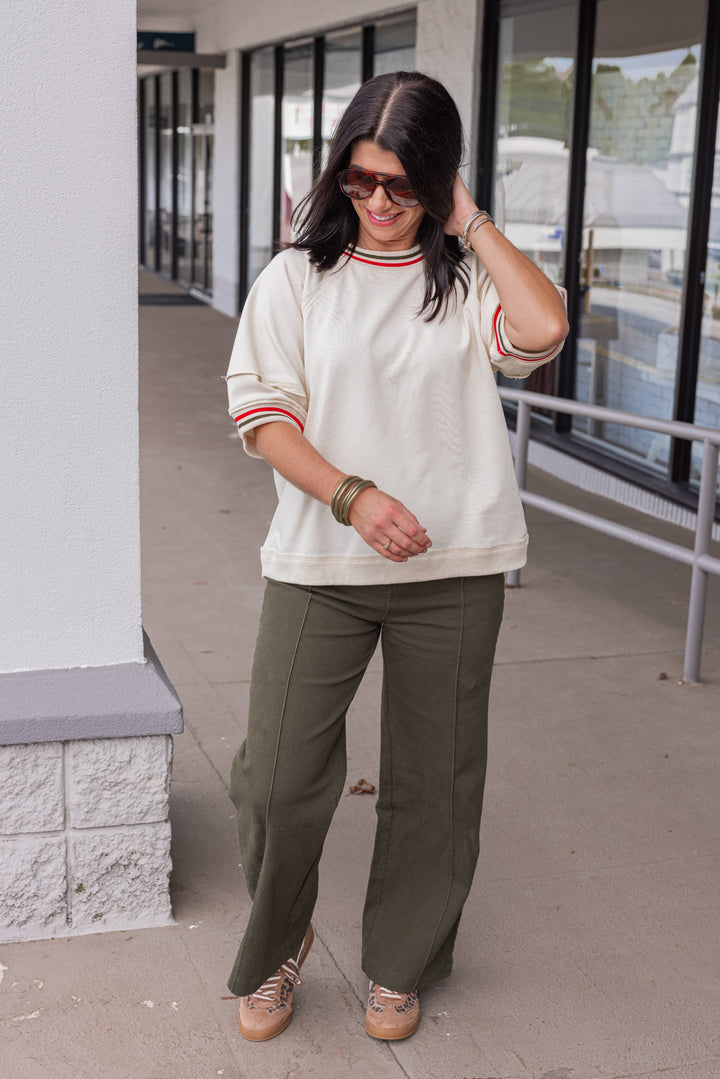 Women's ecru french terry knit top with olive and red striped trim by Entro, perfect for teachers