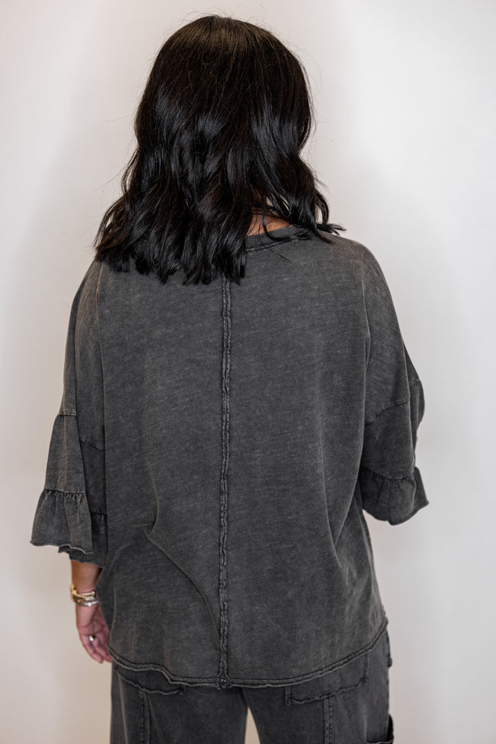 Women's mineral washed black slub top with ruffle trimmed sleeves by Easel showing up close back view