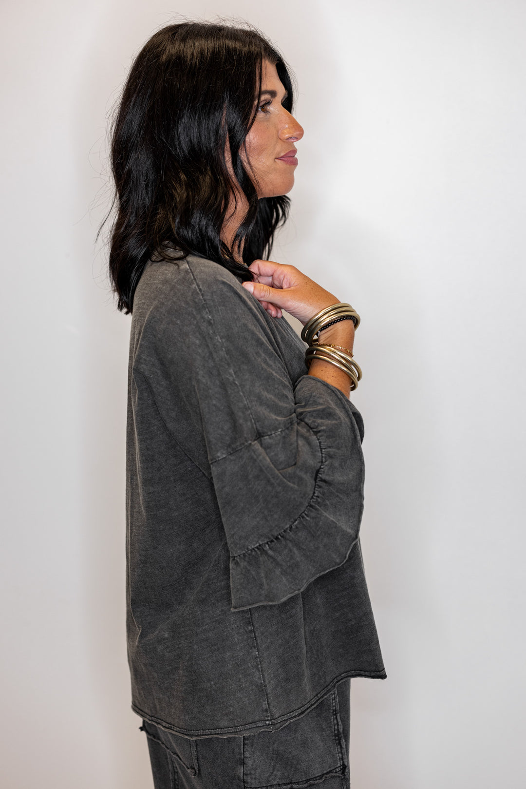 Women's mineral washed black slub top with ruffle trimmed sleeves by Easel showing up close side view