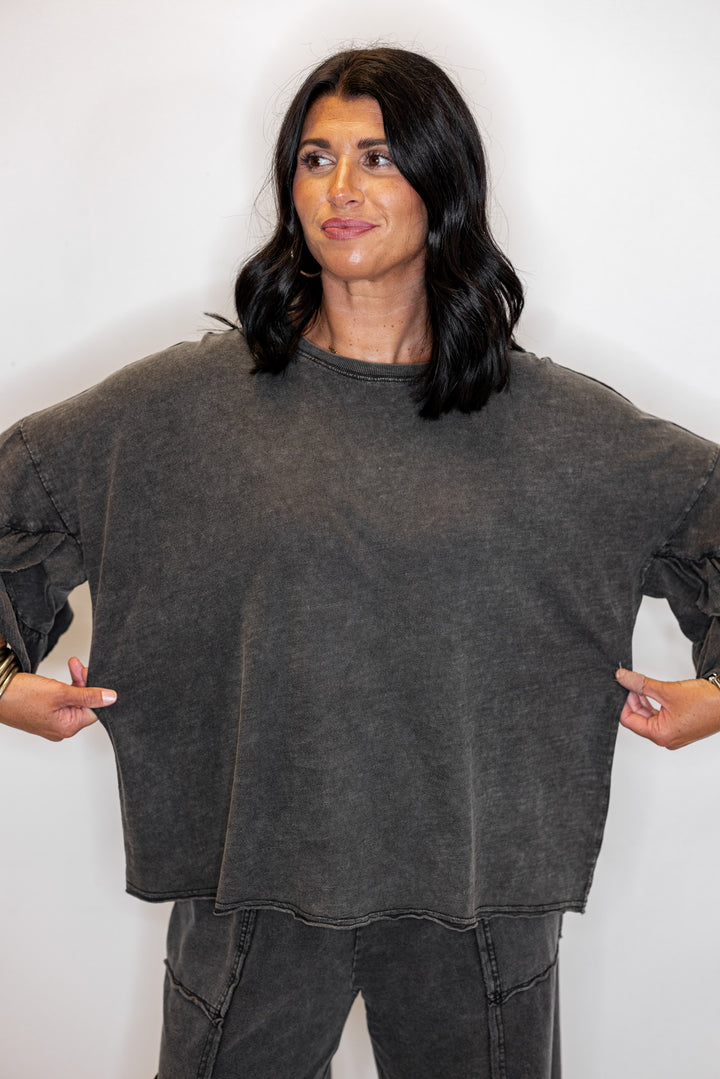 Women's mineral washed black slub top with ruffle trimmed sleeves by Easel showing relaxed silouhette