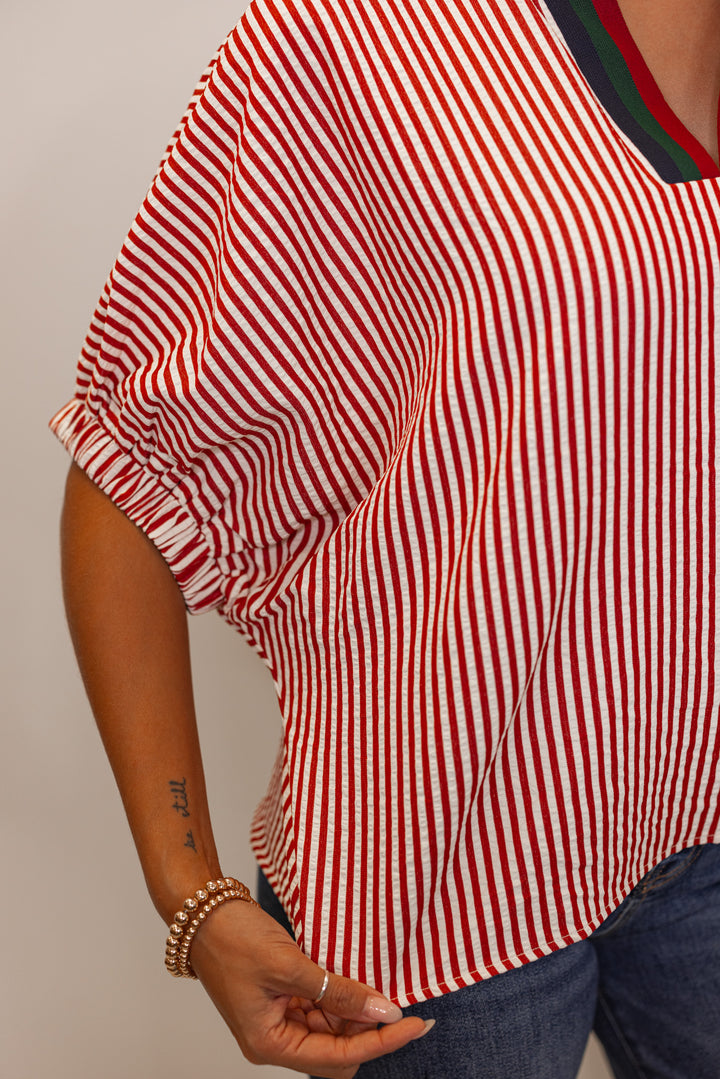 close up view of Women's brick red striped short sleeve top