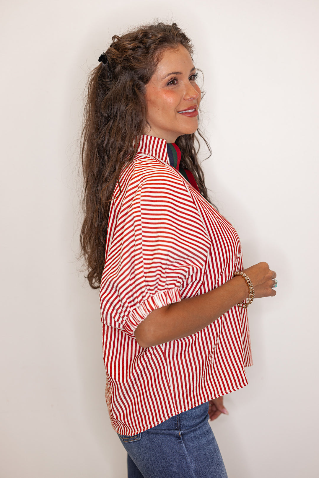 side view of Women's brick red striped short sleeve top