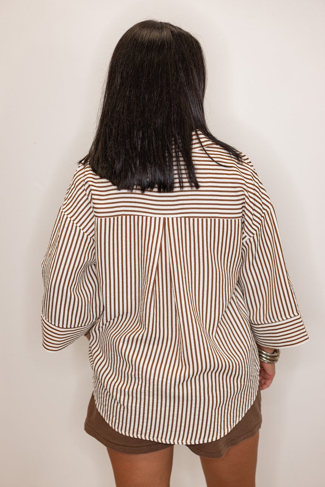 back view of Women's brown and ivory striped 3/4 sleeve blouse