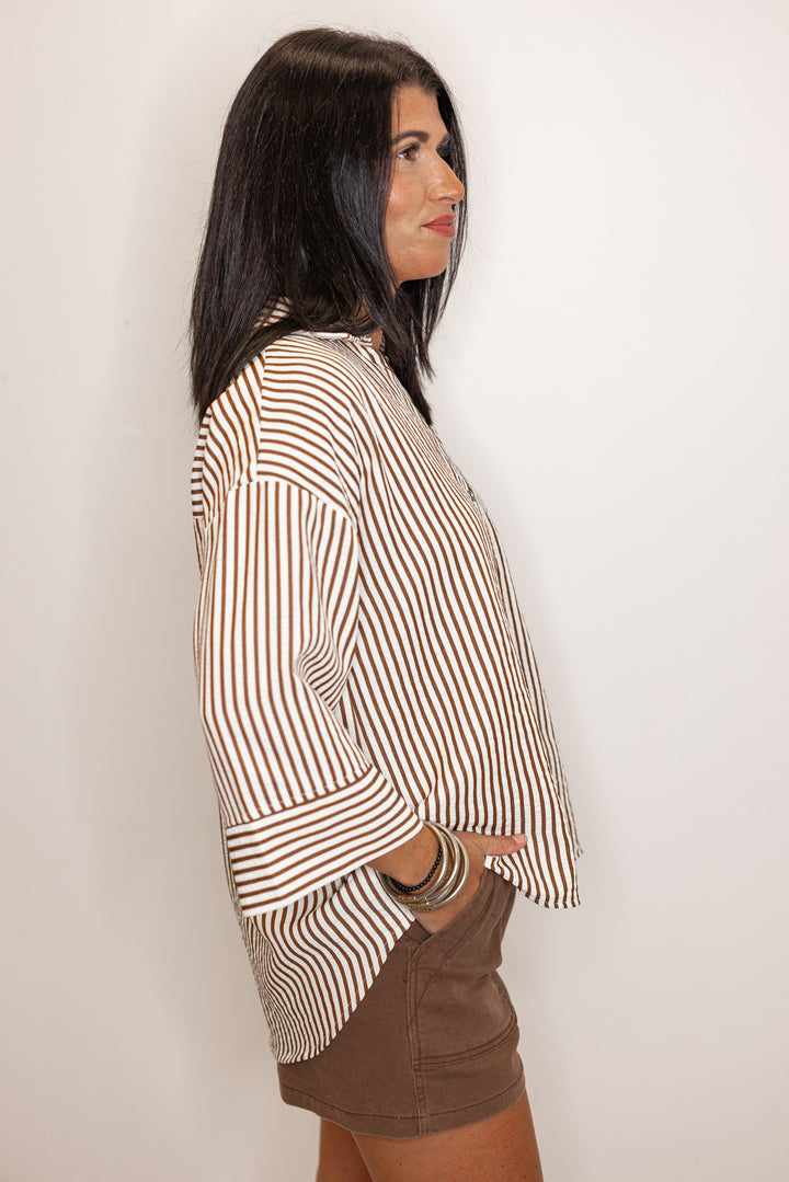side view of Women's brown and ivory striped shirt