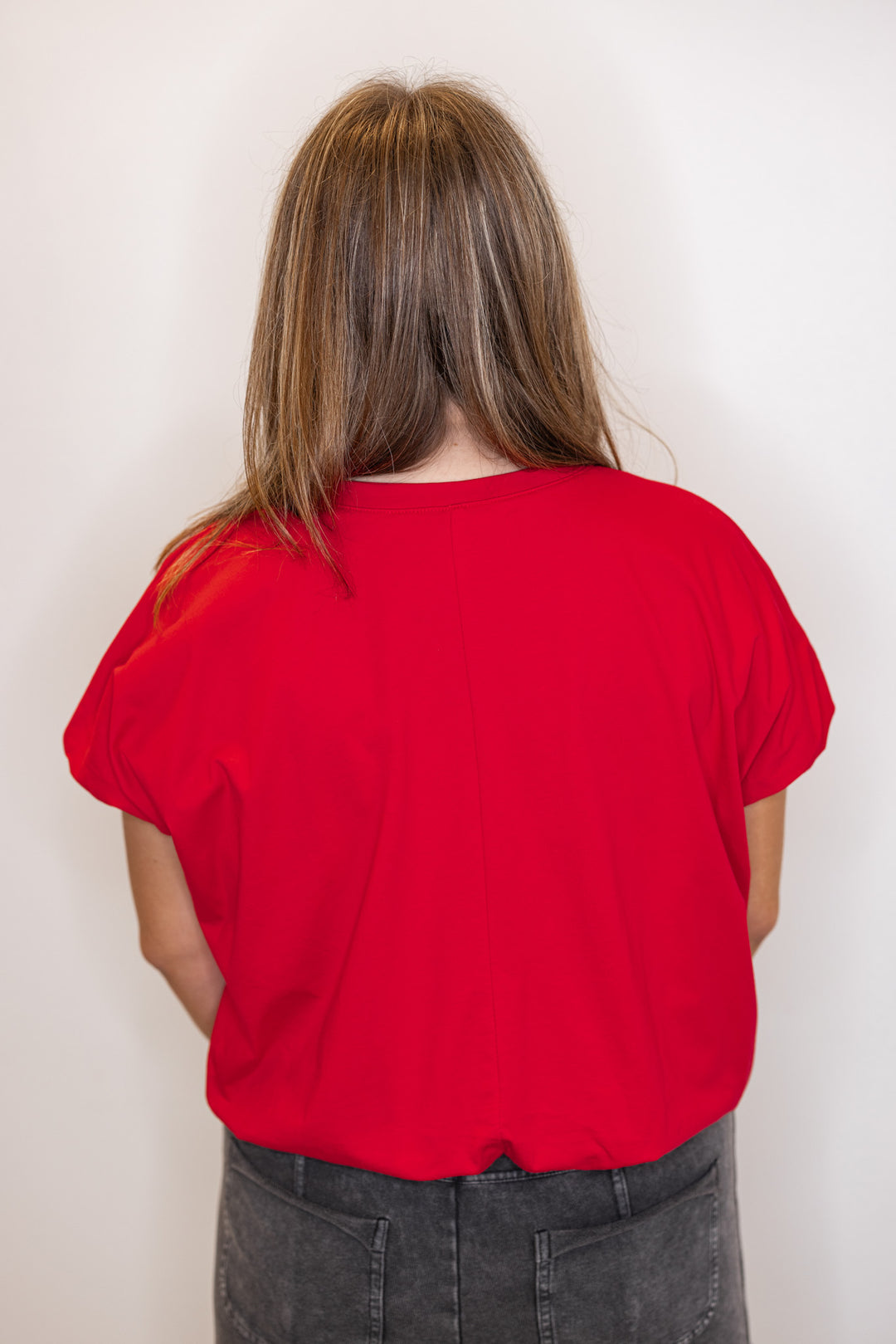 Back view of Women's red Bubble hem top.