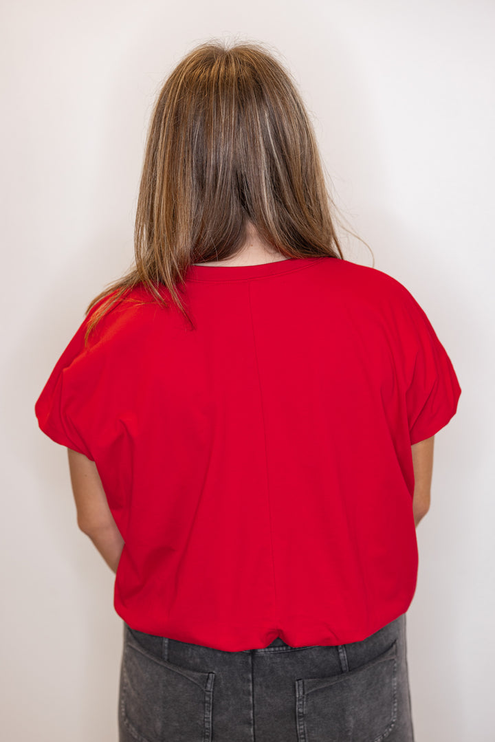 Back view of Women's red Bubble hem top.
