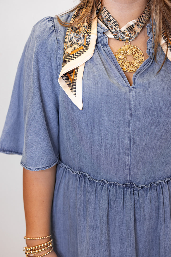 Women's washed blue chambray denim ruffle tiered midi dress with frayed details by Easel showing v neckline 