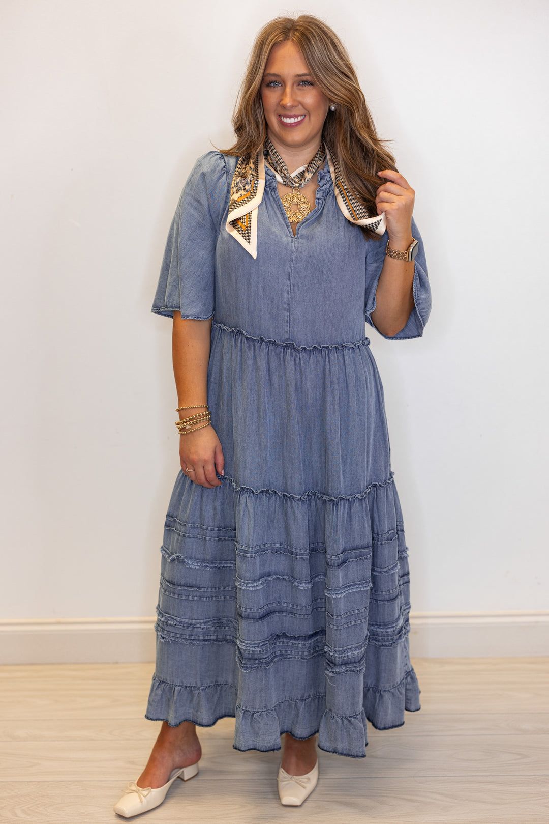 Women's washed blue chambray denim ruffle tiered midi dress with frayed details by Easel showing full front view