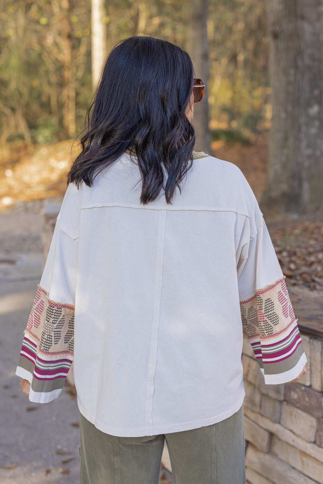 Women's washed ecru knit top with striped trim and floral details at the sleeves by Easel showing up close back view