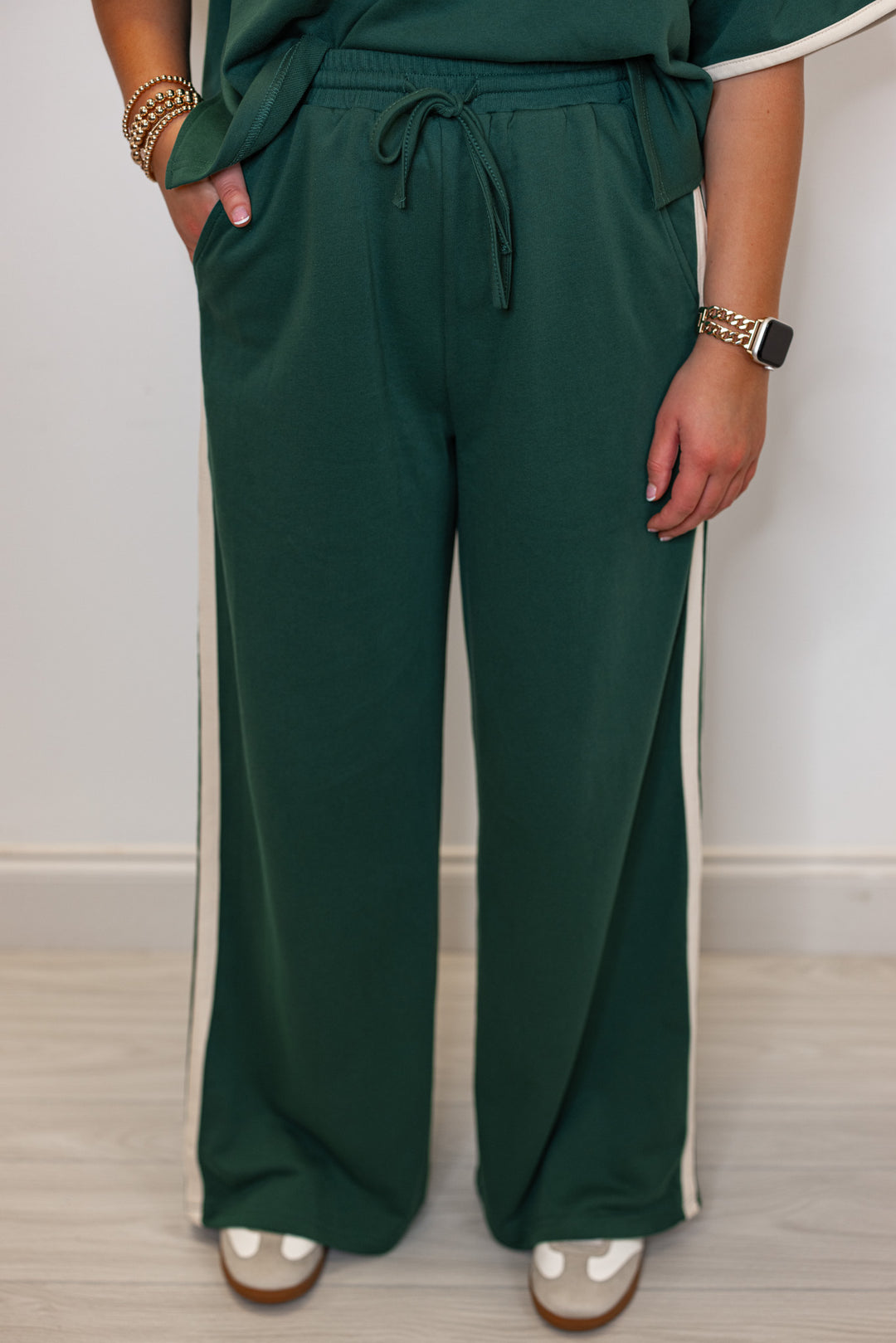 Women's hunter green terry knit wide leg pants with cream stripes on the side by Entro showing up close front view