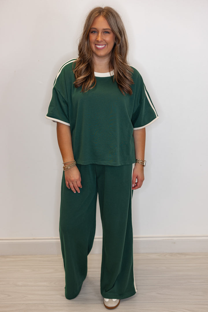 Women's hunter green french terry knit top with cream stripes on the sleeve by Entro showing full front view