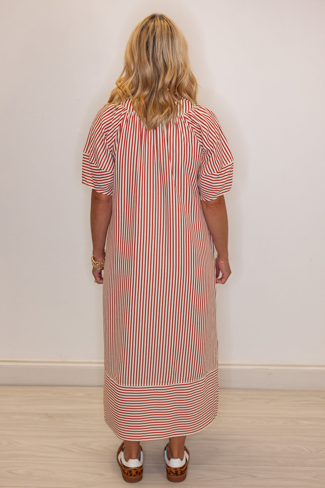 Women's rust and ivory striped midi dress by Entro showing back view