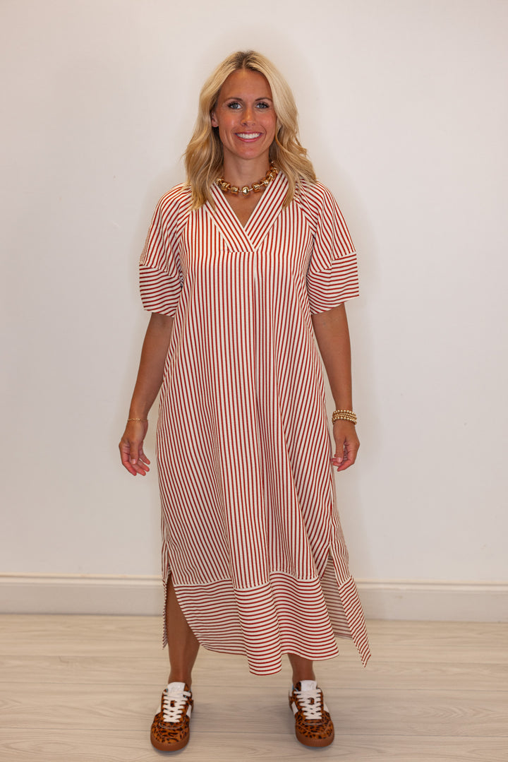 Women's rust and ivory striped midi dress by Entro showing relaxed fit
