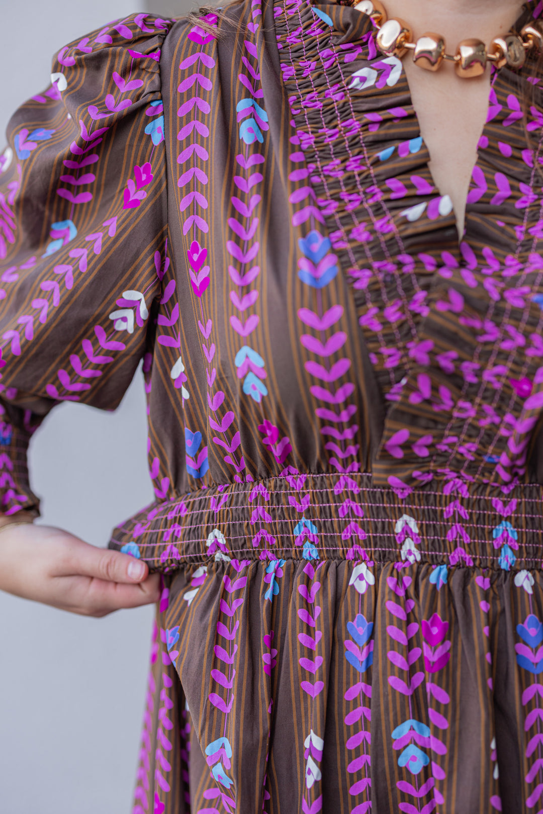 Women's brown ruffle trimmed midi dress with pink multicolor petal print by Umgee showing smocked waistband