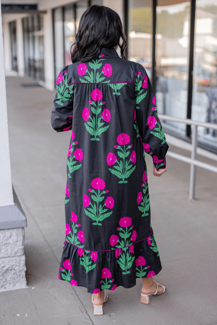 Women's black midi dress with hot pink floral print and hot pink piping trim by Jodifl showing full back view