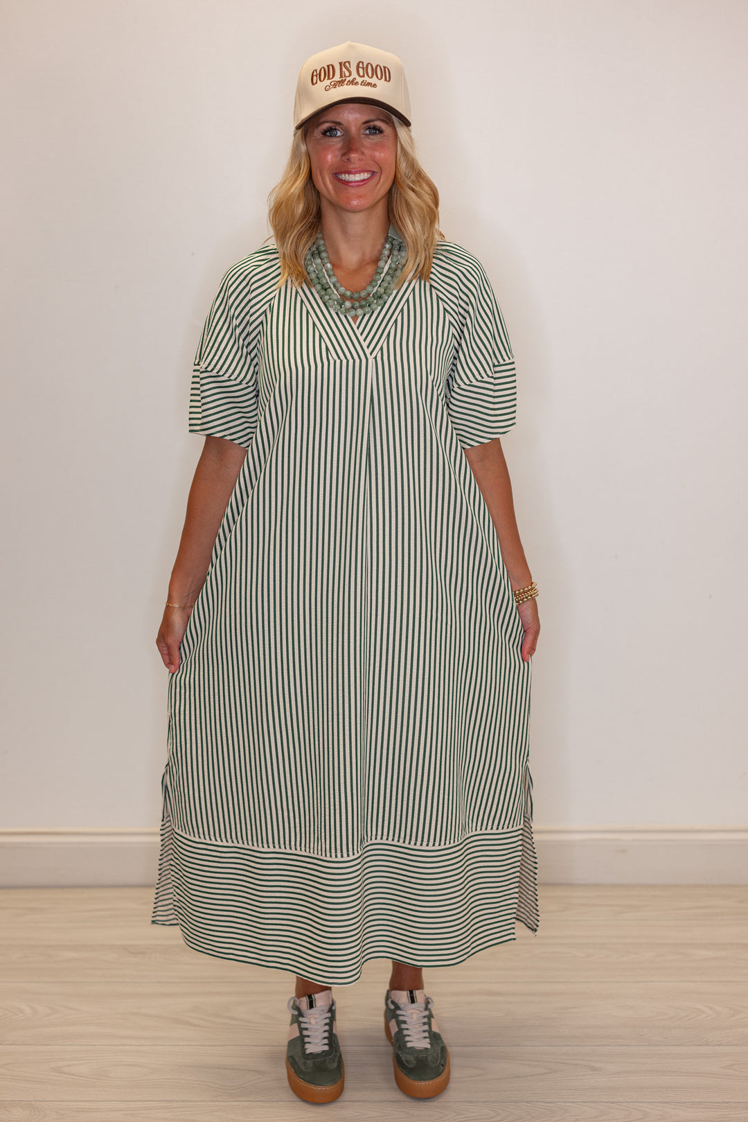 Women's hunter green and ivory striped midi dress by Entro showing relaxed fit