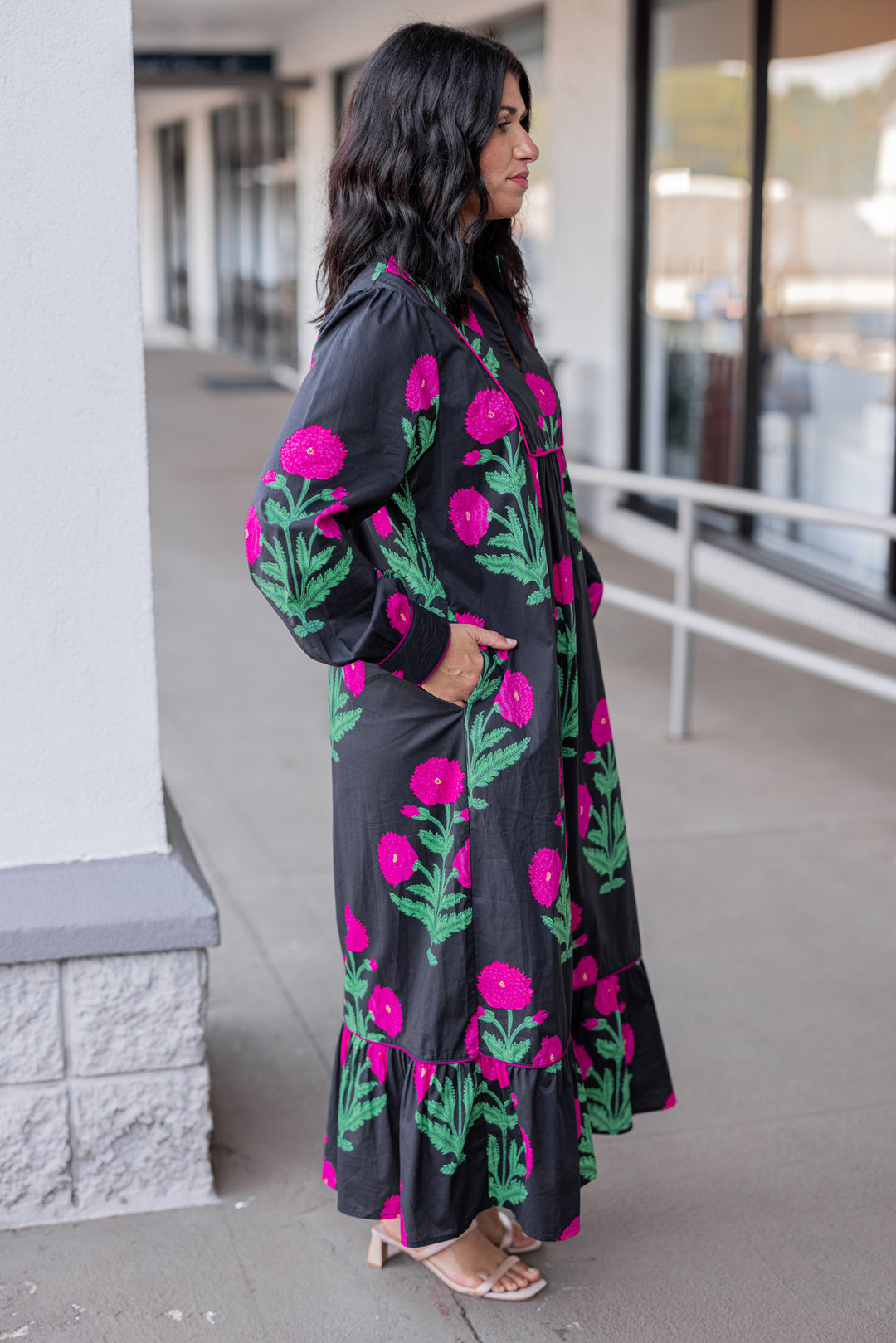 Women's black midi dress with hot pink floral print and hot pink piping trim by Jodifl showing full side view