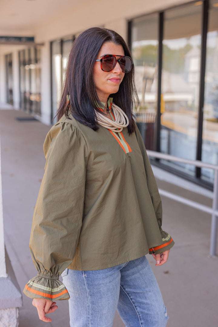 Women's olive poplin top with orange and light olive trim by Jodifl showing side view