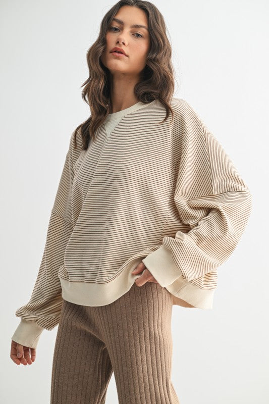 Women's ecru and caramel striped knit long sleeve pullover top by Wishlist showing side view
