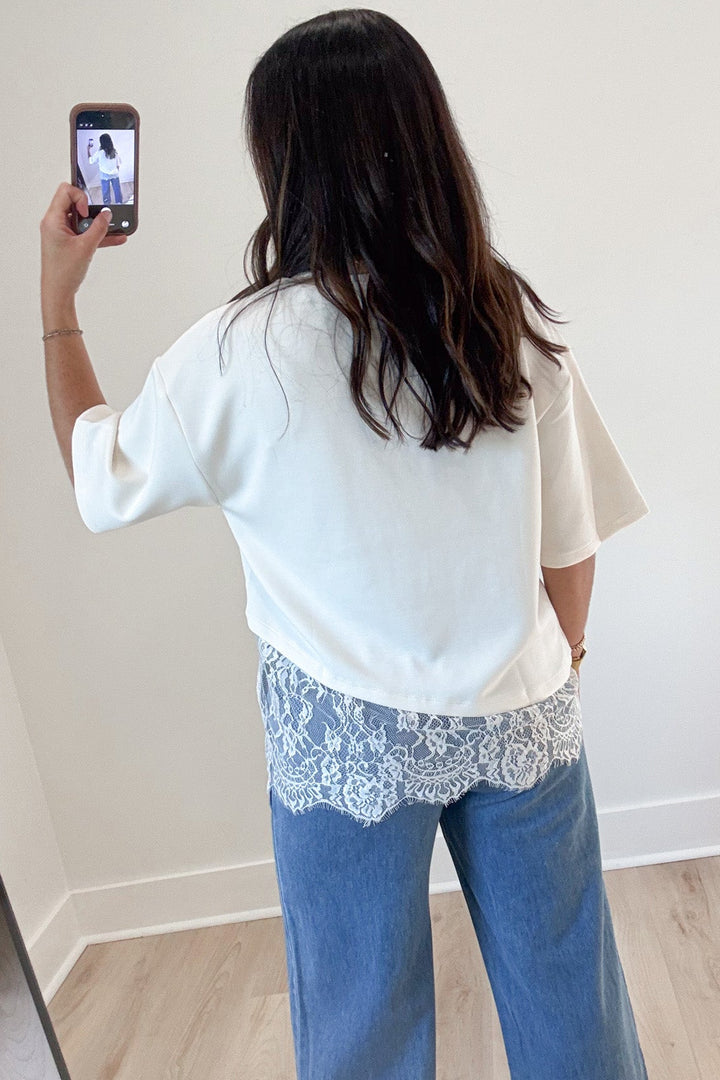 solid ecru scalloped hem short sleeve crew neckline top with asymmetrical lace detail