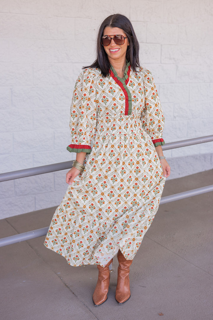 Women's ecru midi dress with orange and green floral print and ruffle trim by Entro