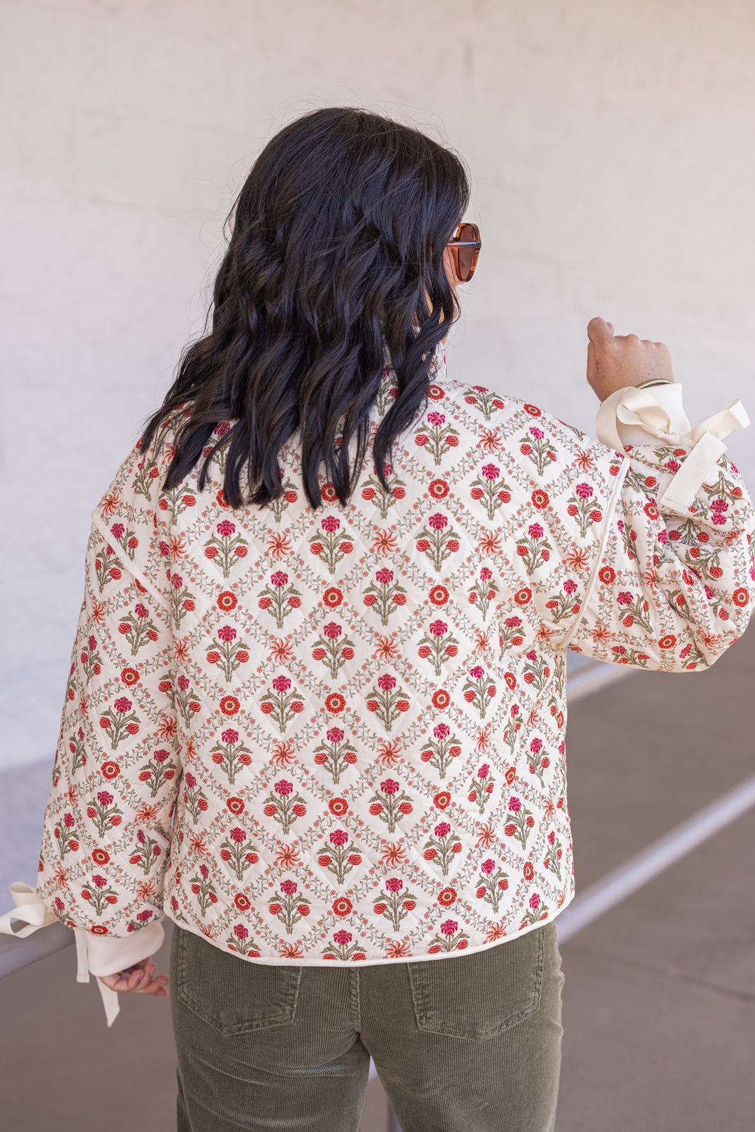 Women's ivory, red and olive floral quilted puffer jacket with bow tie detail sleeves by &merci showing back view