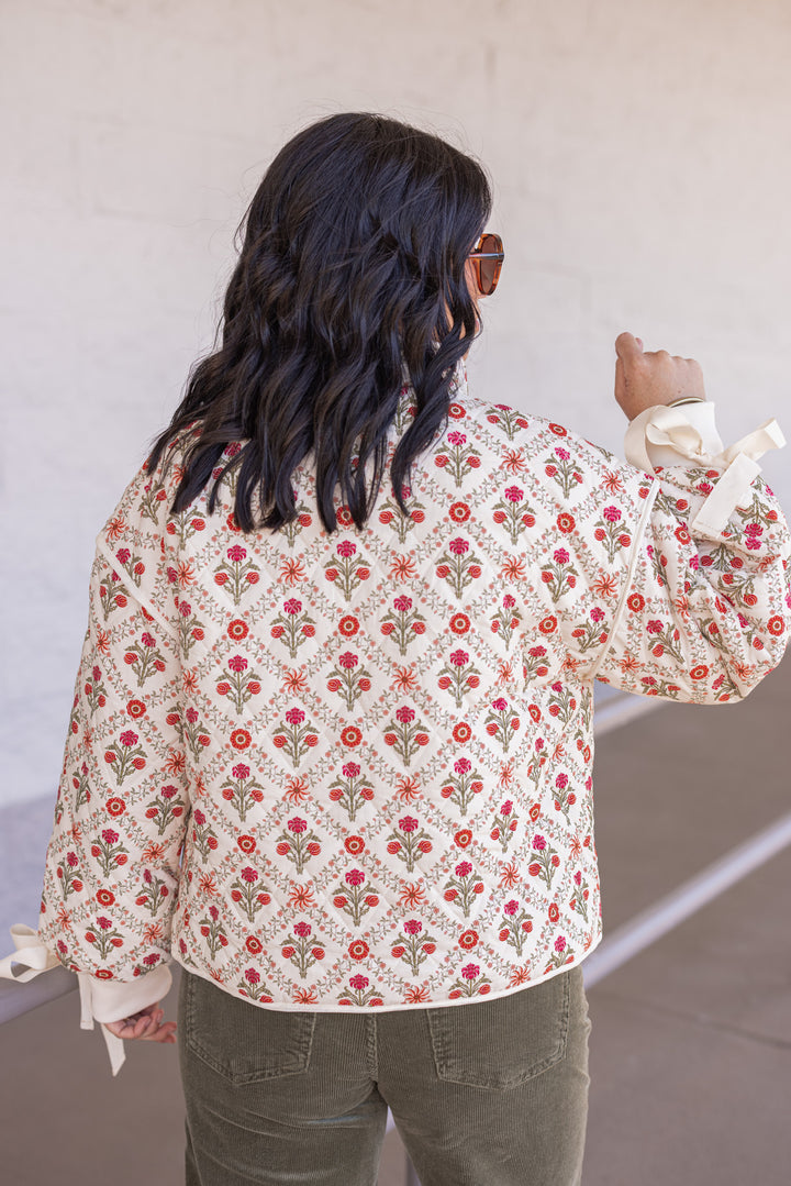 Women's ivory, red and olive floral quilted puffer jacket with bow tie detail sleeves by &merci showing back view