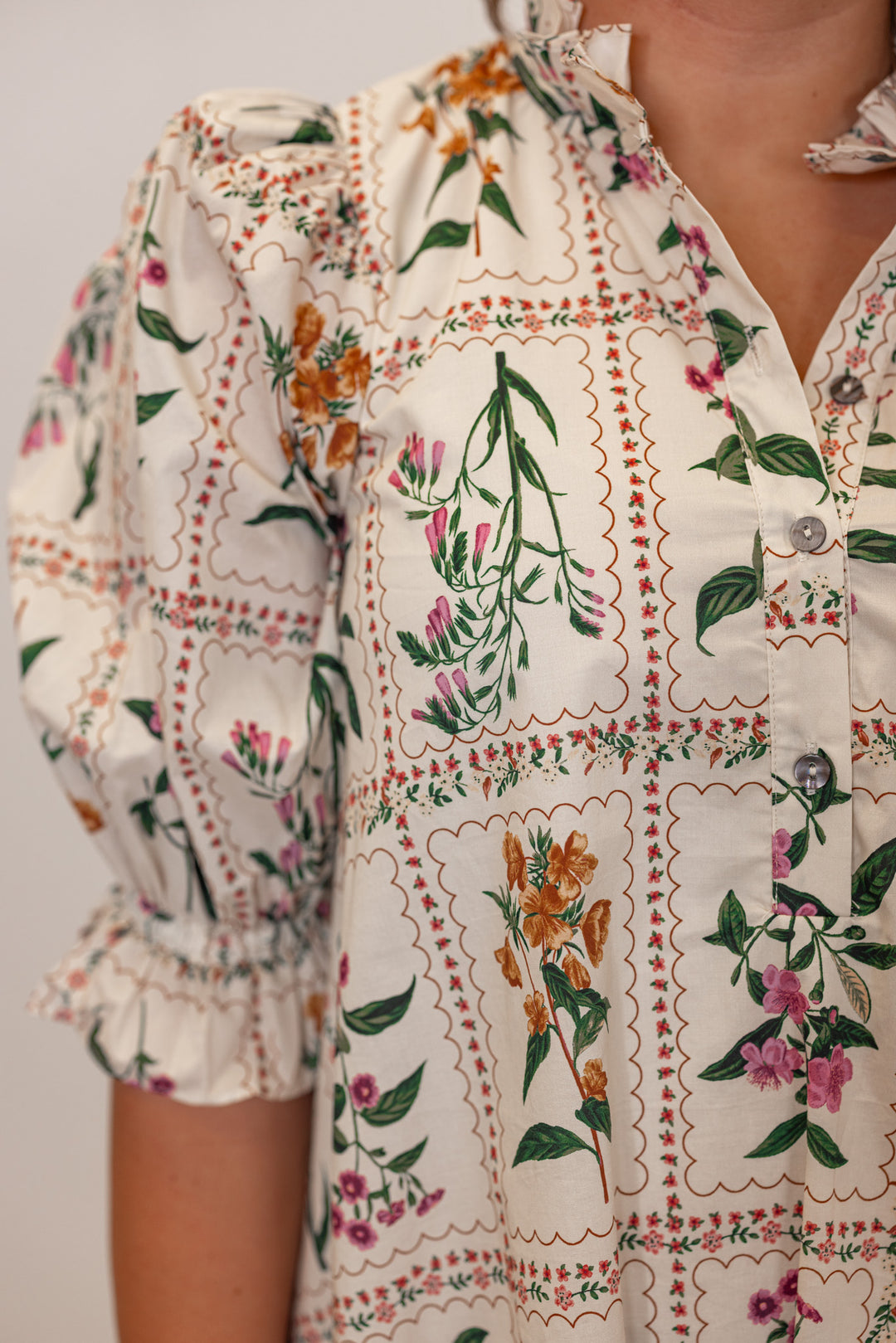 Women's ecru dress with multicolor floral panel print and adjustable cinch waist by Entro showing up close detail