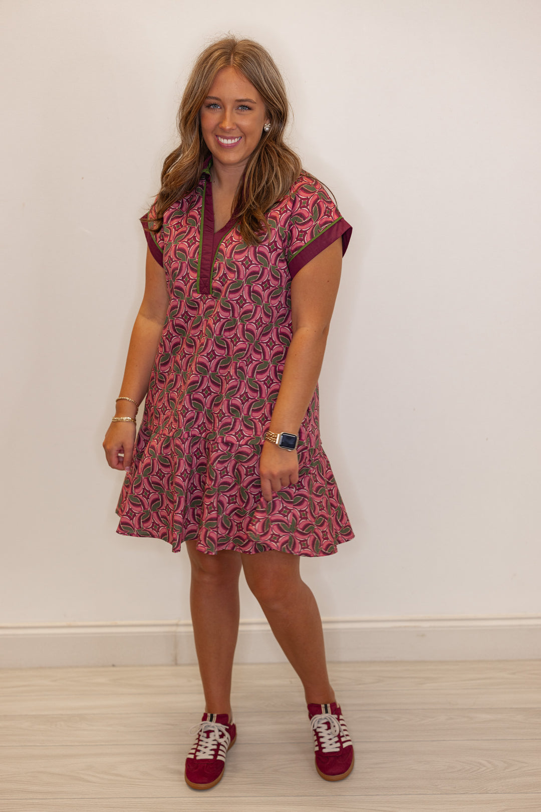 Women's burgundy, salmon and olive green abstract print dress by Entro showing tiered bottom hem