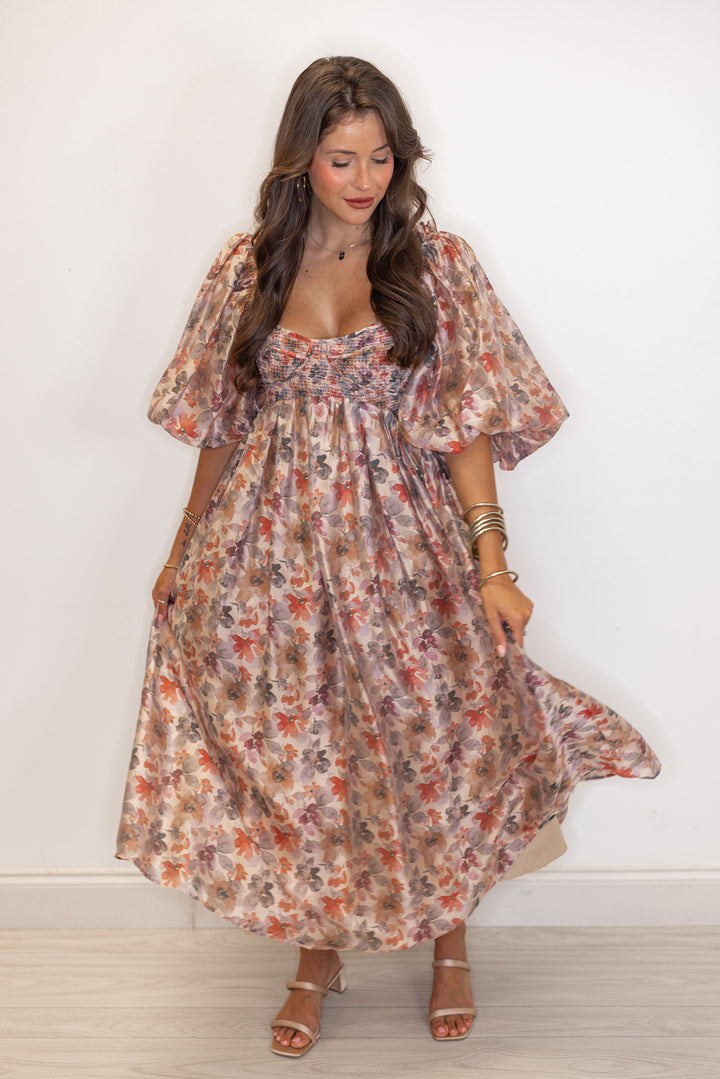 Women's champagne and multicolor floral chiffon midi dress with smocked bodice by Sofie the Label showing flowy skirt