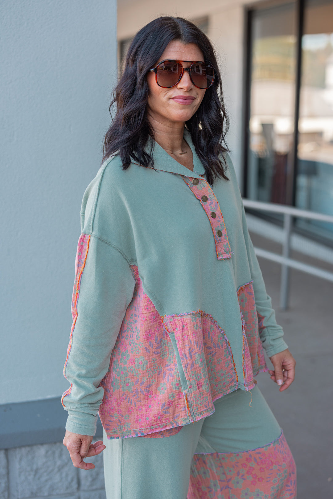 Women's french terry knit sage pullover top with frayed floral patch gauze details by Easel showing side view